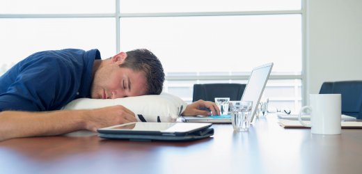 Over-worked business executive sleeping at desk